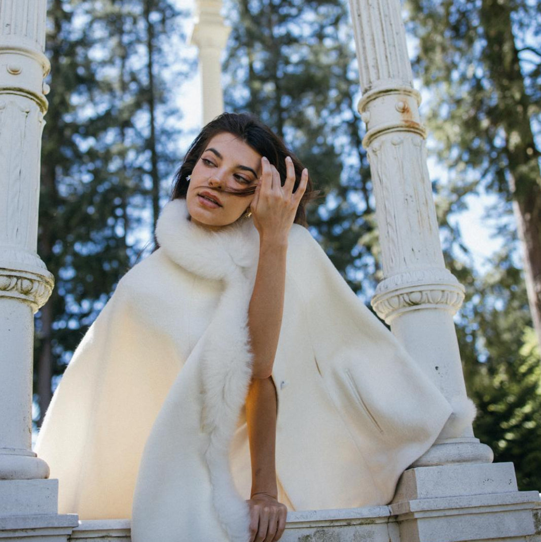 Woman in a ivory fur cape made of baby alpaca